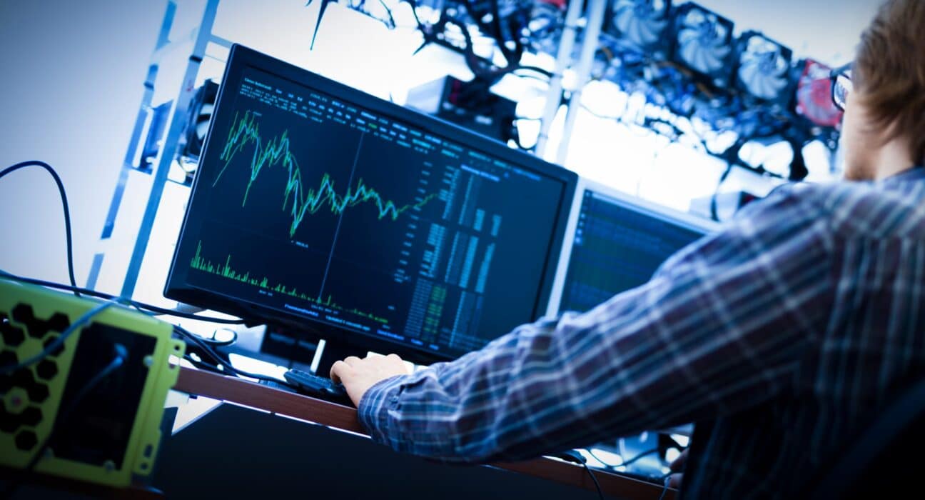 man working on the computer with bitcoin analyst s PKA7WAC scaled 1