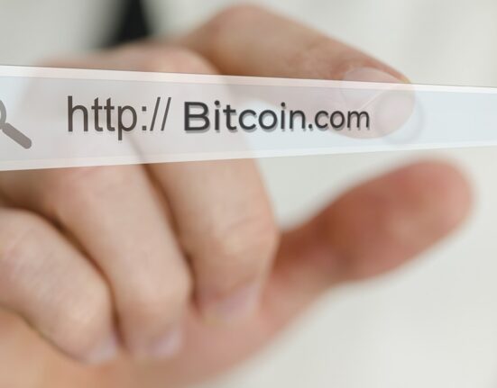 Screenshot of Bitcoin.com domain listing with GoDaddy branding.