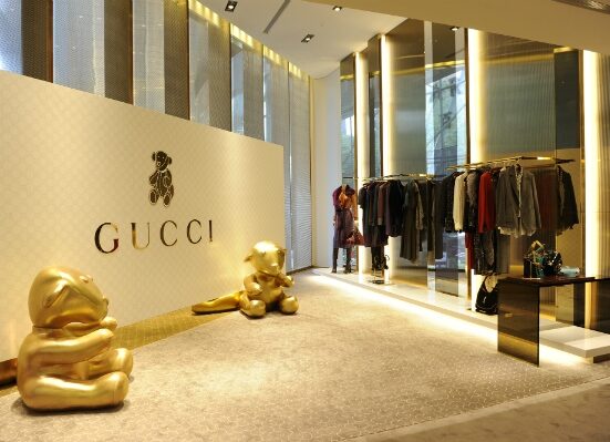 Gucci logo alongside NFT-inspired digital artwork.