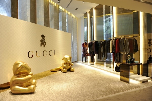 Gucci logo alongside NFT-inspired digital artwork.